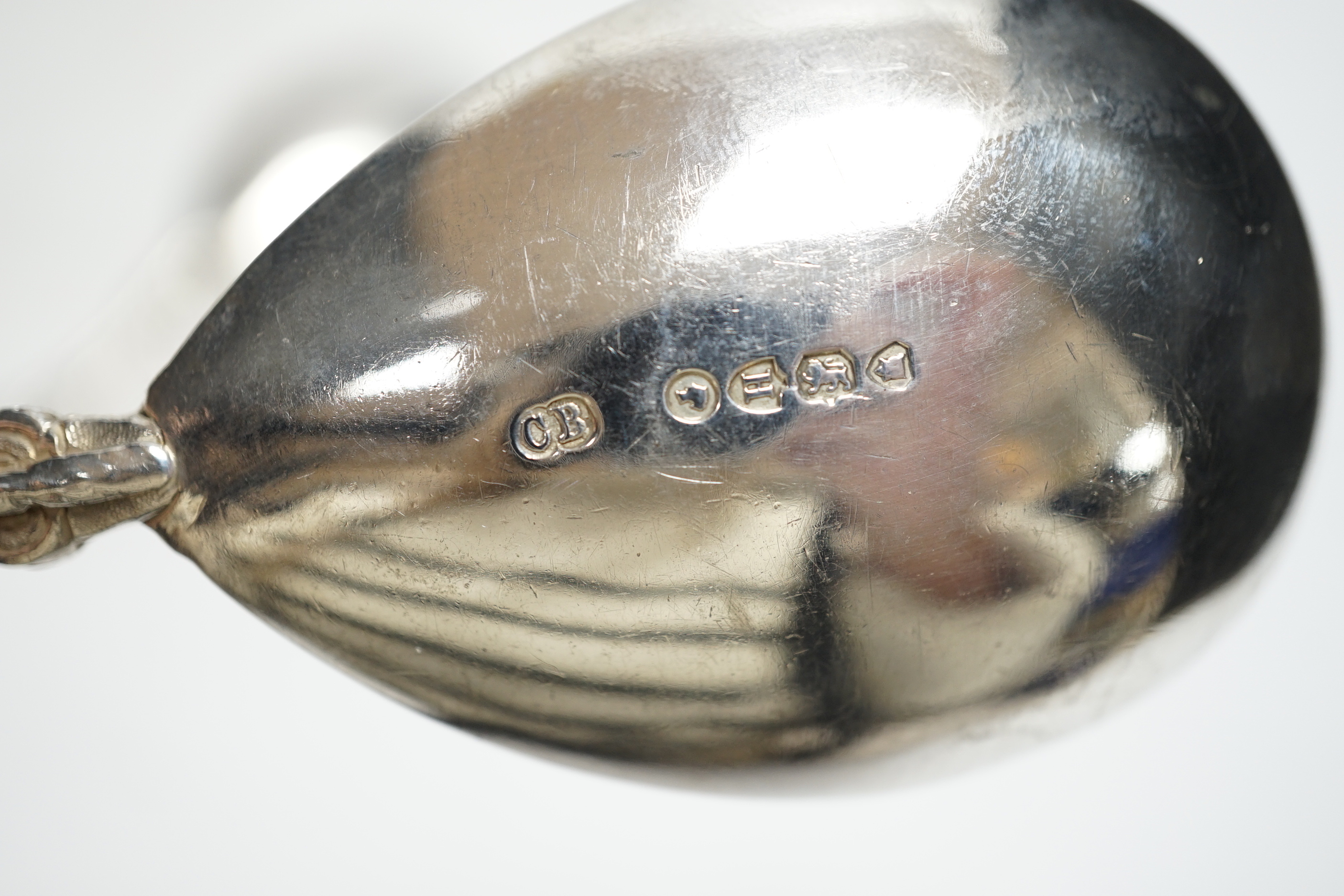A pair of Victorian silver serving spoons, with figural handles and phoenix terminals, Charles Boyton, London, 1882, 18.9cm, 4.2oz.